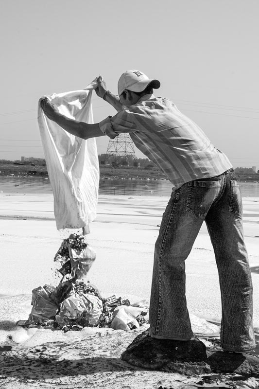 Solid waste being disposed into river Yamuna, National Capital Territory of Delhi, causing water pollution